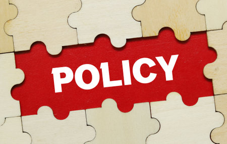 Word POLICY on jigsaw puzzle piece with red background.の写真素材