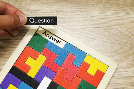 Wooden blocks with the word Questions and Answers on the wooden backgroundの写真素材