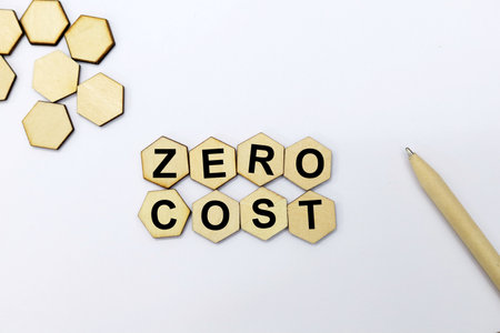 ZERO COST word made of wooden blocks isolated on white background