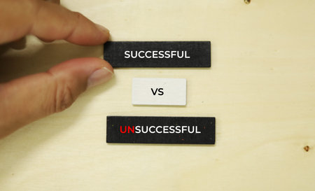 success and failure concept, close up of hand holding a black tag with success and failure text