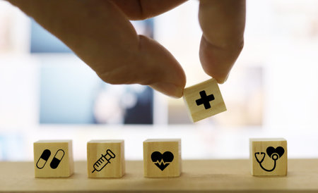 Conceptual image of health care costs and fees. Wooden blocks with medical icons.の写真素材