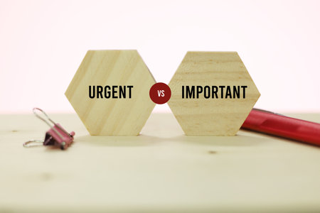 Conceptual image with two wooden hexagons with the words URGENT IMPORTANT