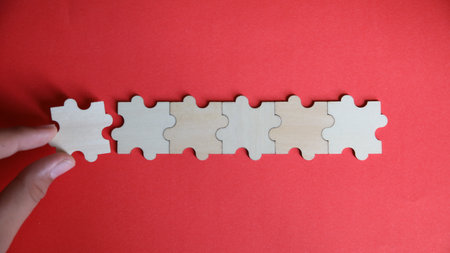Puzzle pieces on red background. Business concept. Top view.の写真素材
