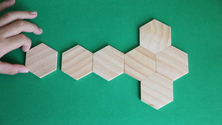 Wooden blocks on a green background. The concept of teamwork and cooperation.の写真素材