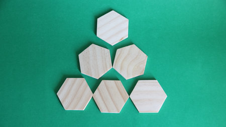 Wooden rhombus on green background. Business and finance concept.の写真素材