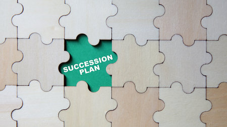 Jigsaw puzzle pieces with word SUCCESSION PLANの写真素材