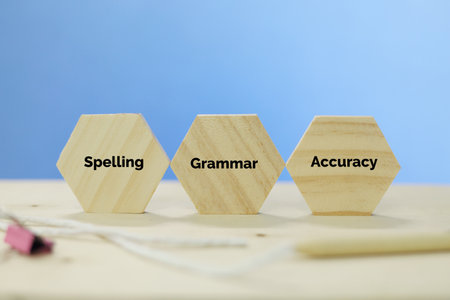 Wooden cubes with the word SPELLING GRAMMAR ACCURACYの写真素材