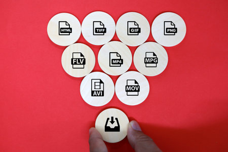 File format icons on wooden circles on red background. Copy space.の写真素材