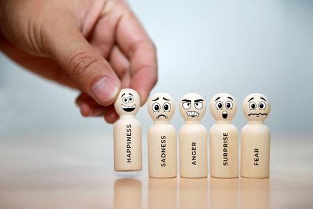 Conceptual image of human resources management and recruitment. Wooden figures with emotions icons.の写真素材