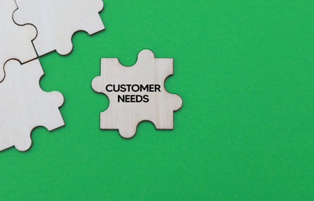 Business concept image of Jigsaw puzzle pieces with word CUSTOMER NEEDSの写真素材