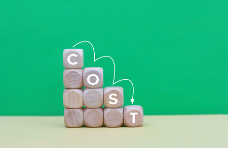 Wooden cubes with the word COSTS on a green backgroundの写真素材