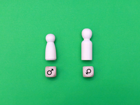 Conceptual image of question and answer. Wooden figures on green backgroundの写真素材