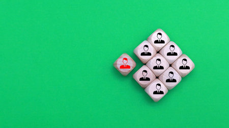 Wooden cubes with people icons on green background. Business and communication conceptの写真素材