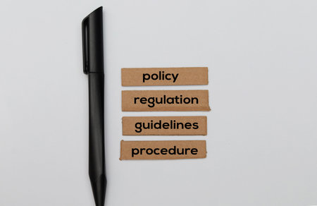Pencil and paper with the words Policy, Regulation, Regulation, Regulation.の写真素材