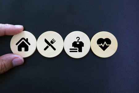 Concept of health insurance with icons on wooden circles, black backgroundの写真素材