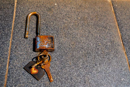 iron keys and lock look rusty on black ceramicの写真素材