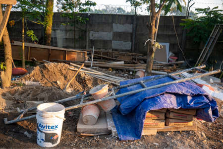 Depok, Indonesia - July 8th 2021 : piles of materials for home renovation, seen sand, cement, stairs, and buckets. Photographed in the morningのeditorial素材