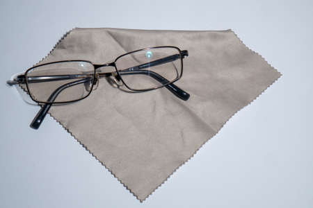 sunglasses with black frames with cleaning cloth on white surfaceの写真素材