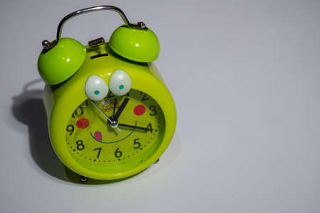 toy alarm clock for children in green on white background