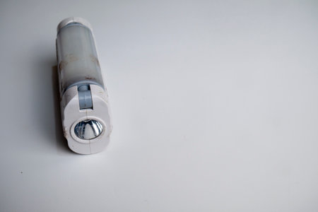LED emergency light is white with two sides that can produce light, can be recharged using USB, photographed closely upの写真素材
