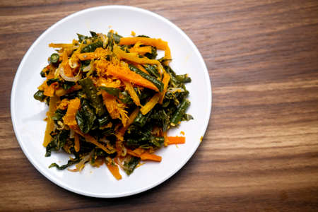 made with boiled vegetables dressed with spiced grated coconut topping called Urapの写真素材