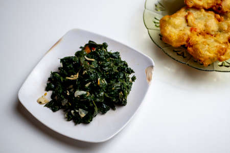 Papaya leaf vegetable with anchovy granules accompanied by fried snacksの写真素材