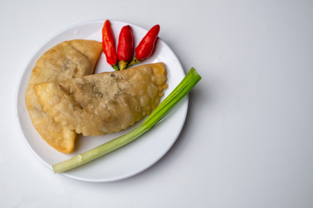 Spicy Cireng, Indonesian Traditional Streed Food with red chili and vegetable on white plateの写真素材
