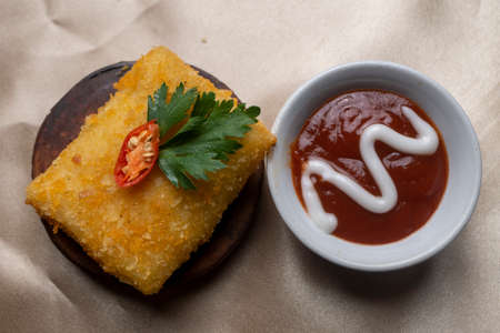 Delicious Risoles on circle wood and chili sauce on little white bowl
