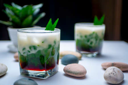Two glasses of Es Cendol, Indonesian traditional dessert, an iced sweet dessert that contains...