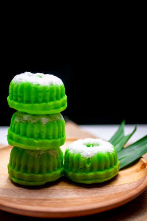 Putu Ayu, Indonesian Traditional food on wooden plate photographed close up, decorated with leavesの写真素材
