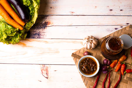 Sambal Bawang, Onion Chili Sauce on wooden table, decorated with onions, chilis, and vegetables like carrot, salad, eggplantの写真素材