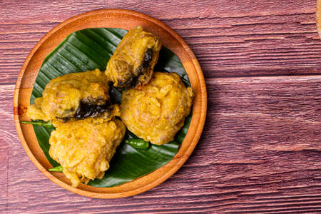 Tahu Petis Crispy, Indonesian traditional food from Semarang City on wooden plate decorated with banana leaveの写真素材