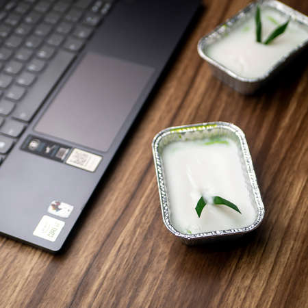 Lumpur Surga, Indonesian Traditional Food, made from coconut milk, egg white and pandan leaves with laptop as backgroundの写真素材