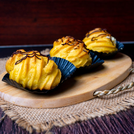 Kue soes coklat, soes coklat, chocolate cream puffs or famous with Choux Pastry Cream Puffs, pastry ball filled with white creamの写真素材
