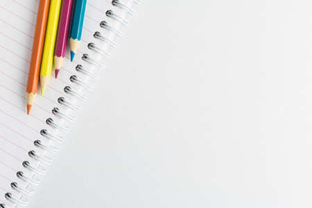 Color pencils and notepad on the white backgroundの写真素材