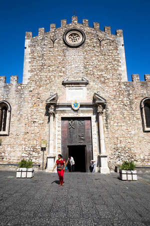 A vistor leaving the entrance to the Fortress Duomo in Taormina, Sicily.のeditorial素材