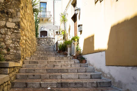 An alley with stairs in the tourist destination of Taormina, Sicily.の写真素材