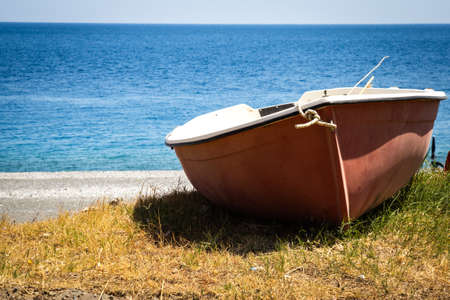 A beached boat on the shore in Sicily.の写真素材