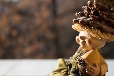 Close up macro shot of a wooden doll in the morning lightの写真素材