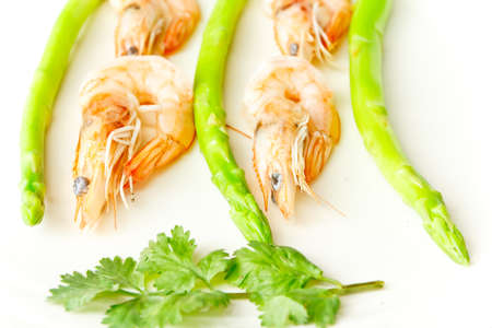 fresh shrimp cooks asparagus on white dishの写真素材