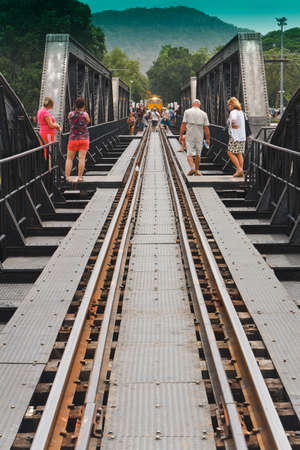 KANCHANABURI, THAILAND - JUNE 15:  unidentified  foreign tourists walking on the bridge over the river Kwai on JUNE15, 2012 Kanchanaburi, Thailandのeditorial素材