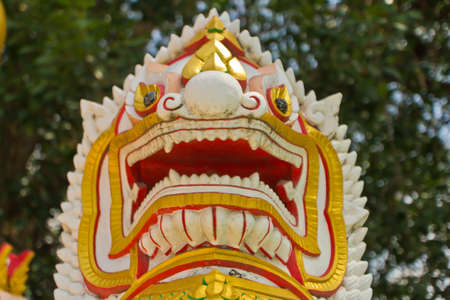 molded lion white figure infront a temple ,