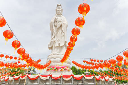 Guan Yin statues, adorned with Chinese lanterns,. In Thailandの写真素材