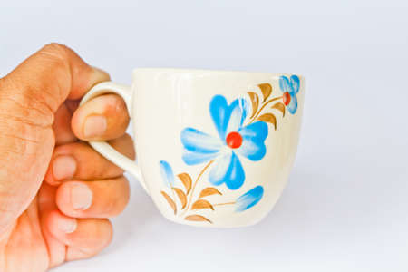 Colorful ceramic cup on a white screen の写真素材