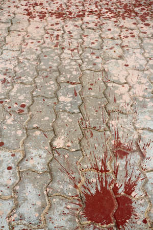 Paint on concrete block on the sidewalk.