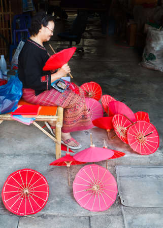 CHIANG MAI, THAILAND - JANUARY 19: Unidentified, Woman making a wooden umbrella in traditional umbrella factory on JANUARY 19, 2014 in Chiang Mai, Thailand.のeditorial素材