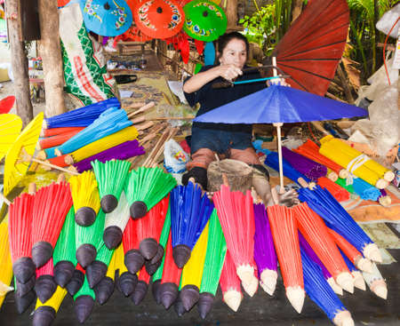 CHIANG MAI, THAILAND - JANUARY 19: Unidentified, Woman making a wooden umbrella in traditional umbrella factory on JANUARY 19, 2014 in Chiang Mai, Thailand.のeditorial素材