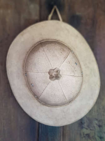 The hat is made of cloth, white.