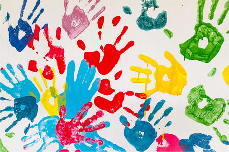 Colorful hand prints on white paper background. Abstract background and texture.の写真素材