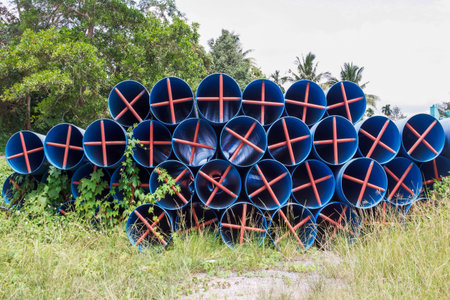 Plastic water pipes stacked on the ground.の写真素材